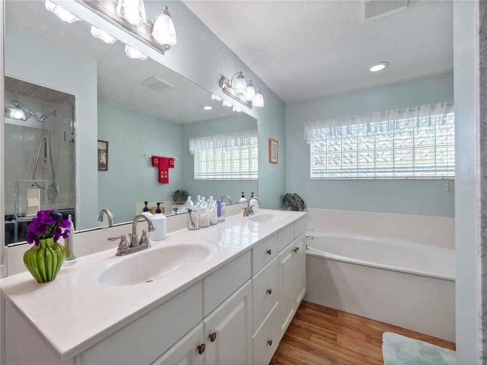 Primary Bath features Dual Sink Vanity, Garden Tub, and Walk-in Shower