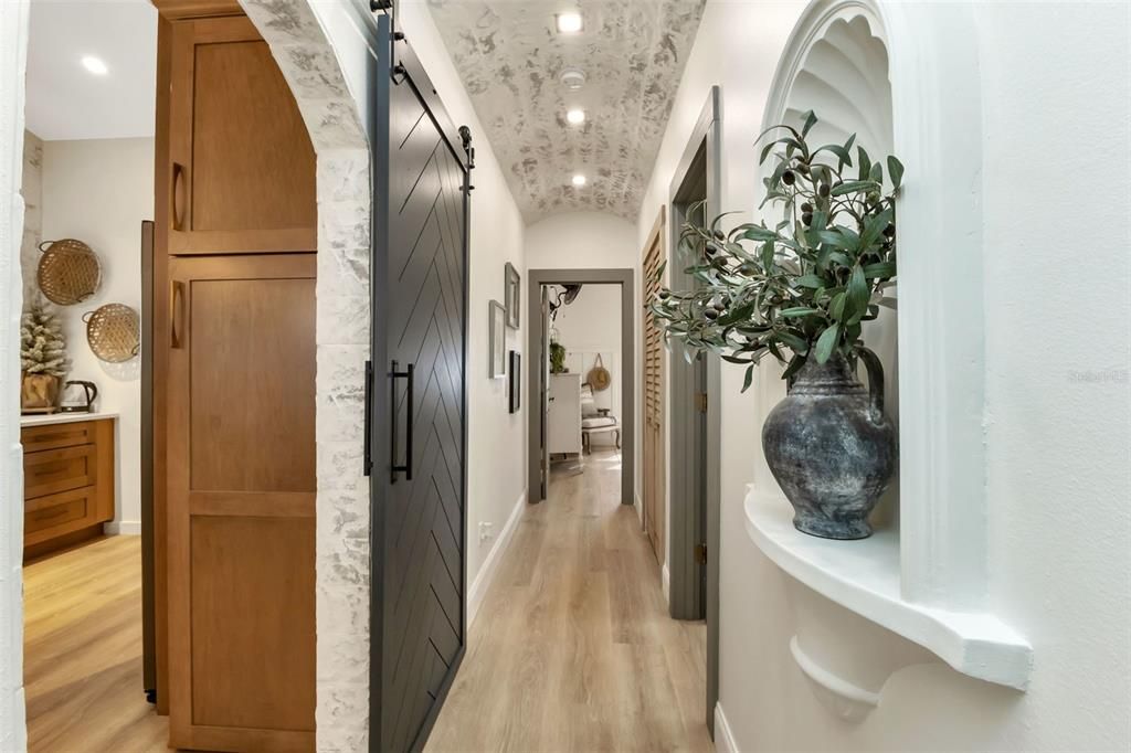 custom doorway hallway leading to bath and two bedrooms. Notice the custom ceiling and niche.