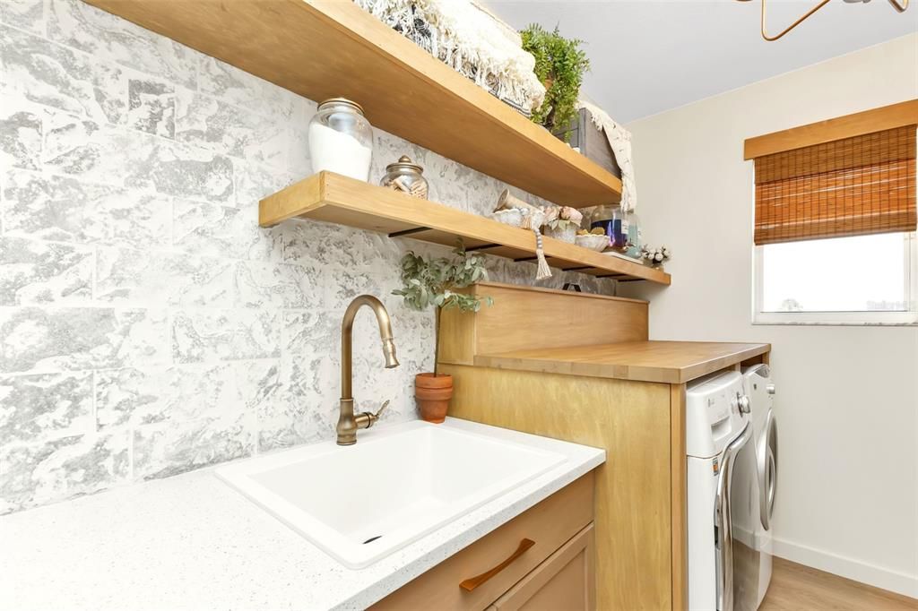 sink area with shelving for easy access to make laundry efficient and pleasurable