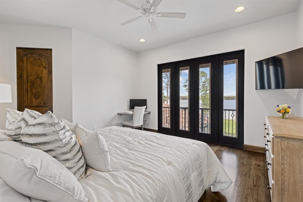 Upstairs third bedroom with soothing natural light and serene lake views, a peaceful retreat.