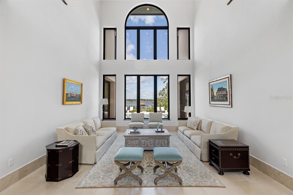 Offering a spacious living room with tall, arched windows that flood the room with natural light.