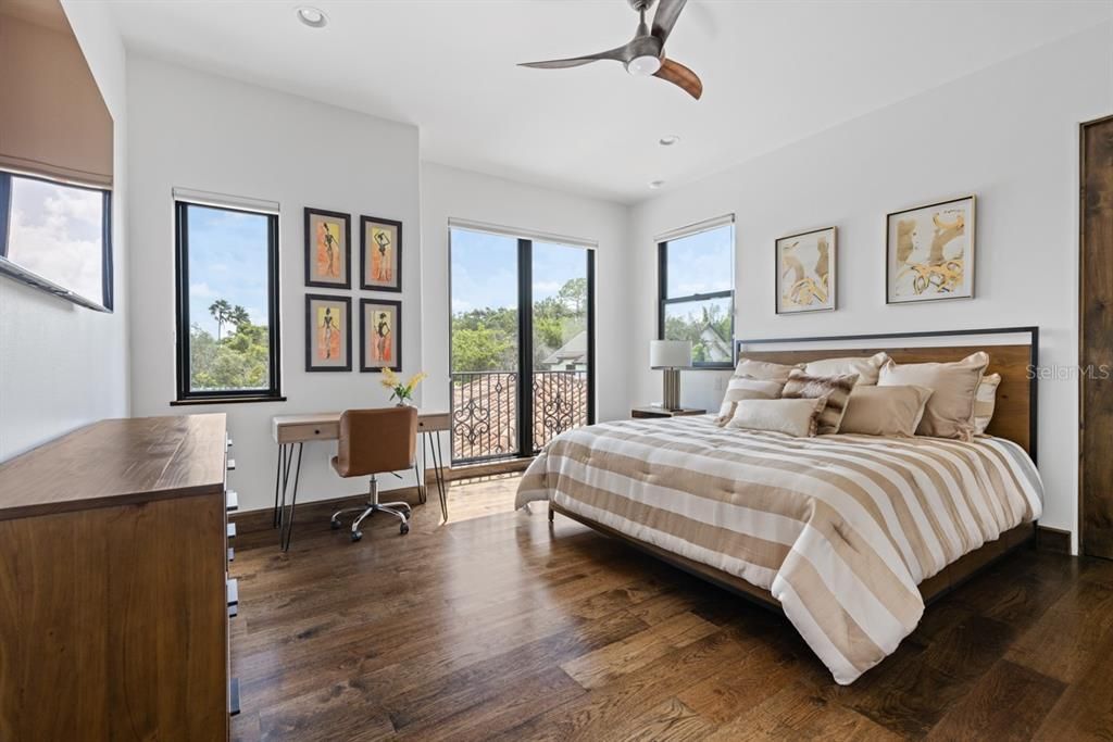 Upstairs second bedroom offering comfort, natural light, and panoramic views of the surroundings.