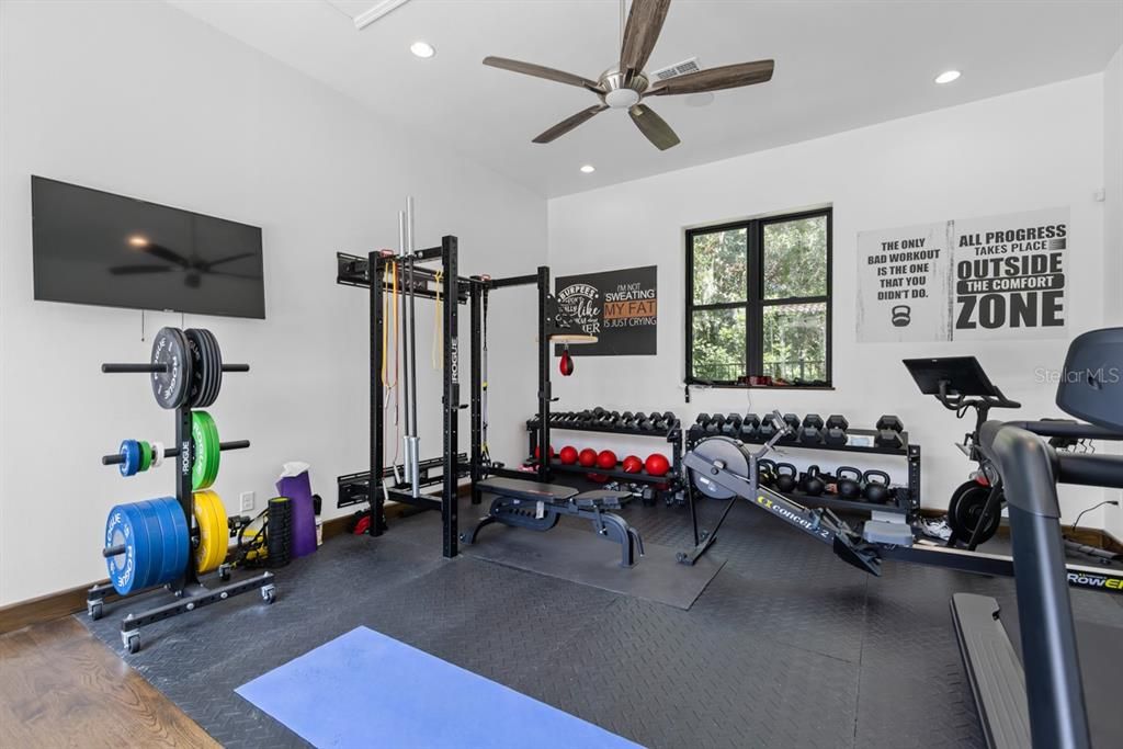 Modern home gym space with ample room for personalized workouts and expansive windows for natural light.