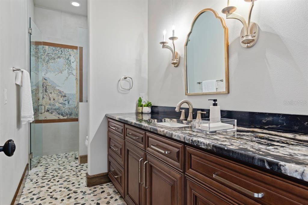 Elegant en-suite guest bathroom offering separate outdoor access for privacy and convenience.