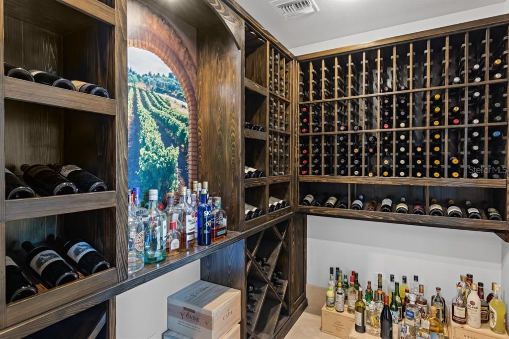 Adjacent to the kitchen and dining room, a custom wine cellar promises indulgence, complete with storage and elegant design details.