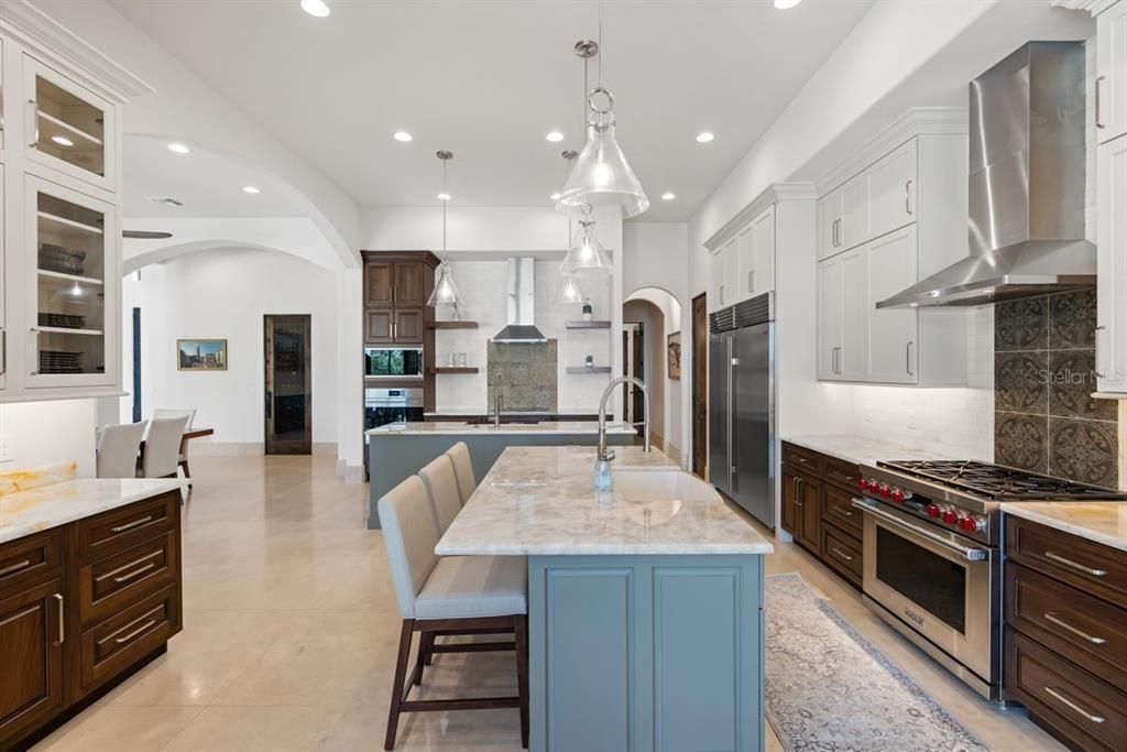 Continuing from the living area, this kitchen unfolds as a connoisseur's delight, with an elegant layout, bespoke details, and state-of-the-art amenities poised for culinary adventures.