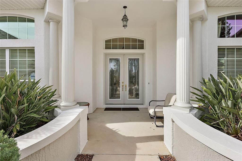 Covered front entrance w/elegant leaded glass double doors