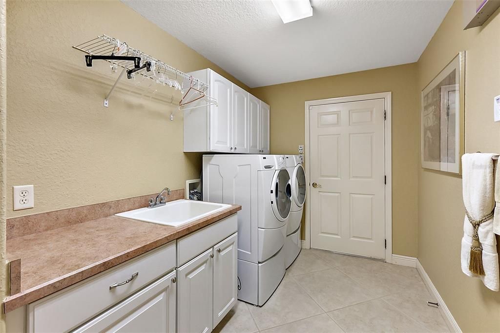 Inside laundry room w/utility sink & extra cabinets