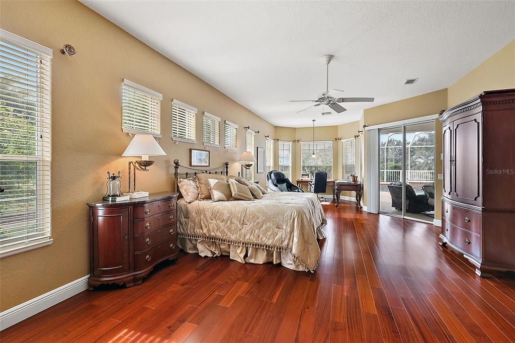 Master bedroom w/access to lanai & wood flooring