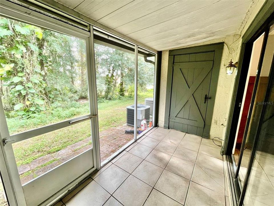 Screened-in and covered back porch with additional storage; no rear neighbors