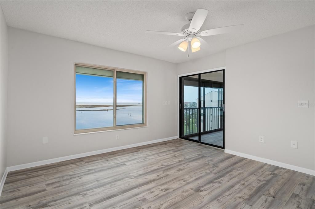 Master suite with bird's eye view of the Gulf of Mexico and sliders to enclosed lanai area