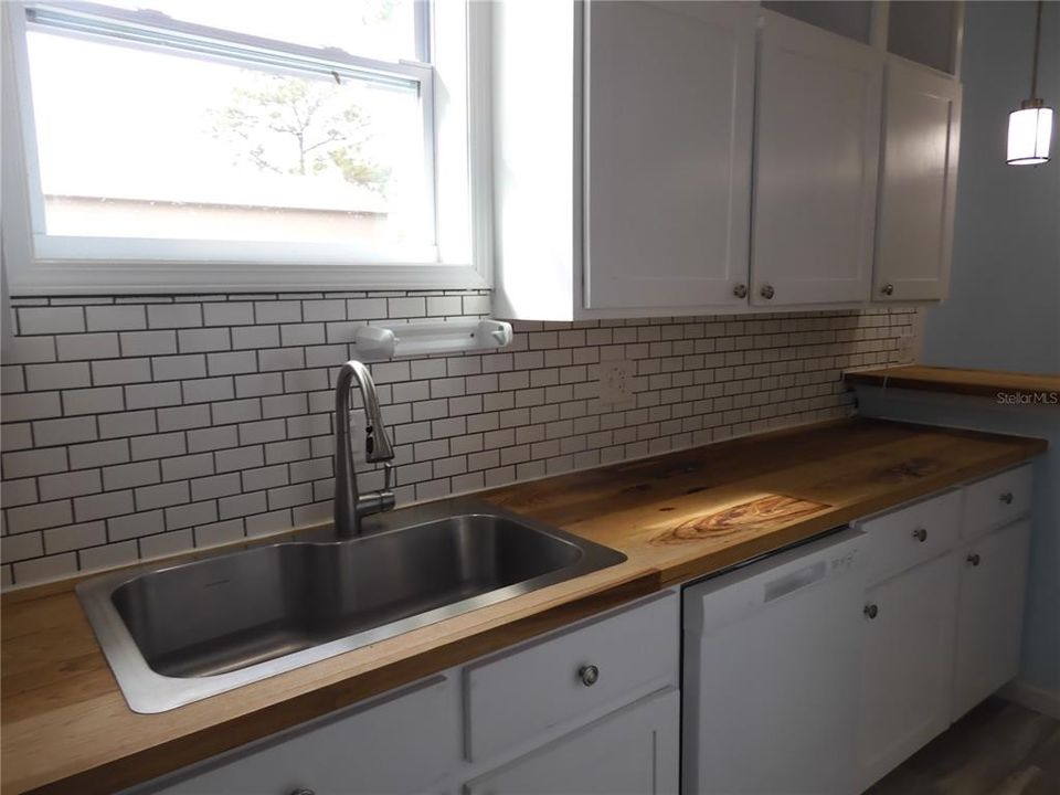 Hickory wood countertop in kitchen &O tiled backsplash