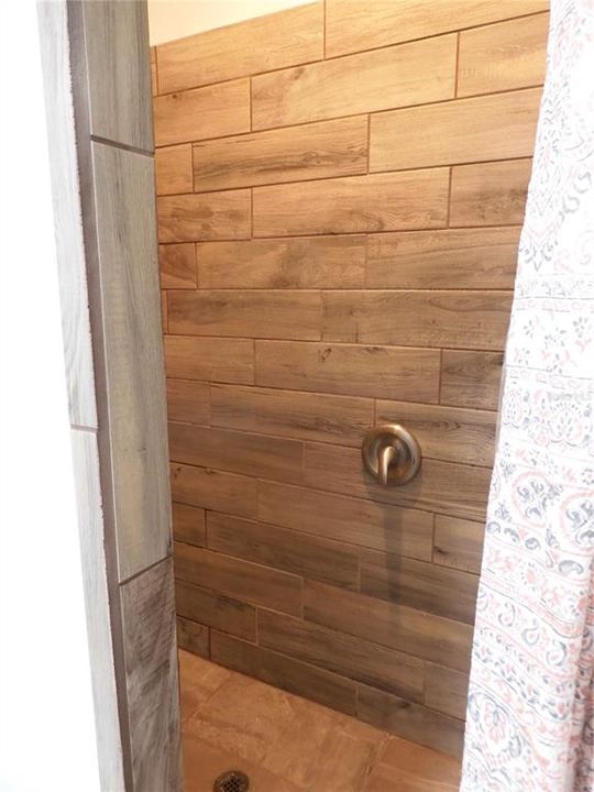 Large tiled step in shower in Master bath