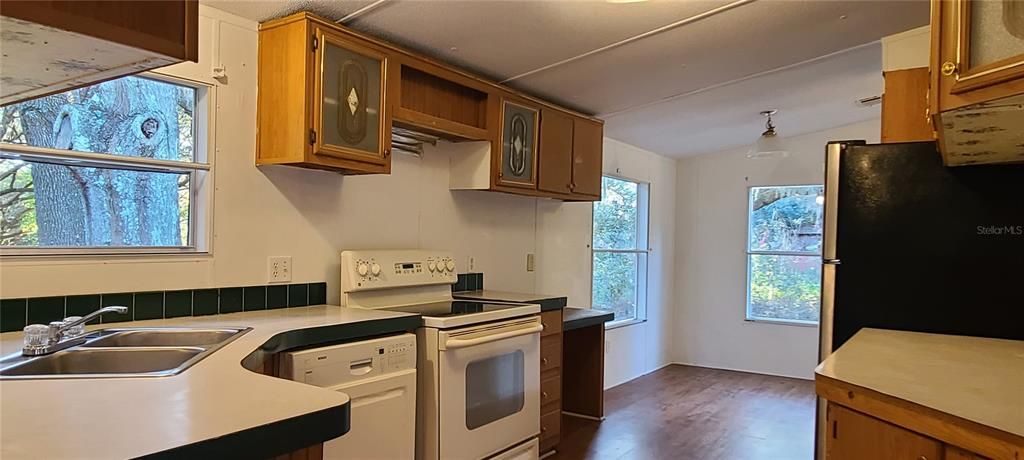 Kitchen with dinette looking out into the spacious landscape.