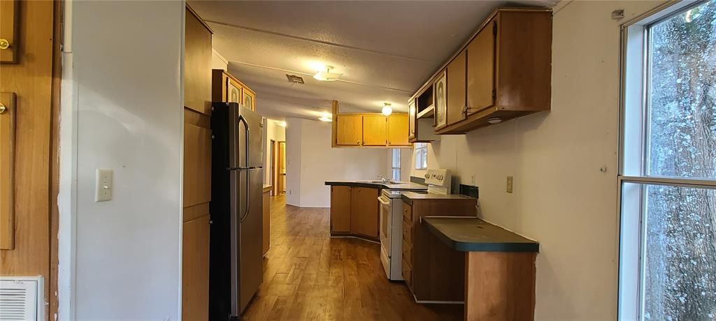 View from dinette area showing built-in desk in kitchen