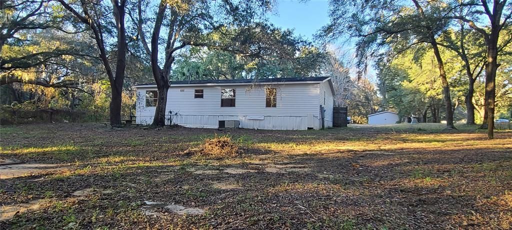 Back of home with large backyard