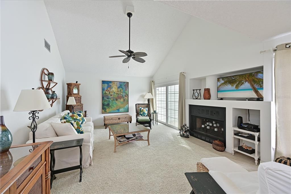 Upon entry, this cozy home has vaulted ceilings and a fireplace.