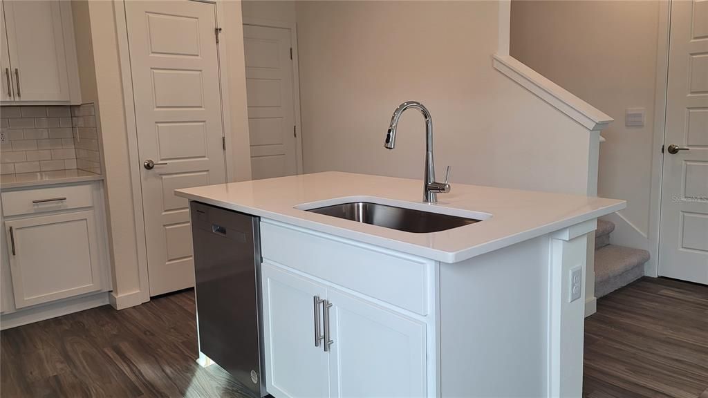 Kitchen island with dishwasher and one tub SS sink.