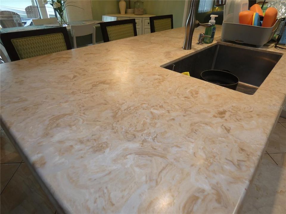 Upscale Quartz countertop throughout kitchen and dining area.