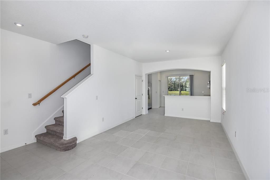 * REPRESENTATIVE PHOTO. Beyond the foyer the heart of this home opens into the family room, complete with a wall of windows that fill the space with natural sunlight.