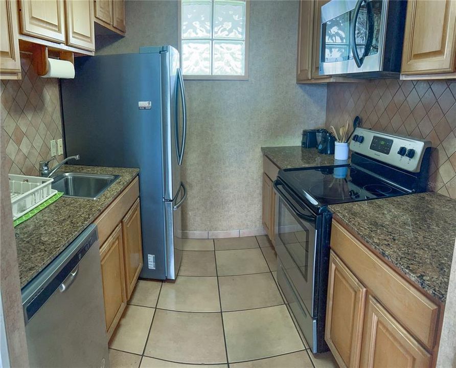 Full kitchen with granite countertops and stainless steel appliances