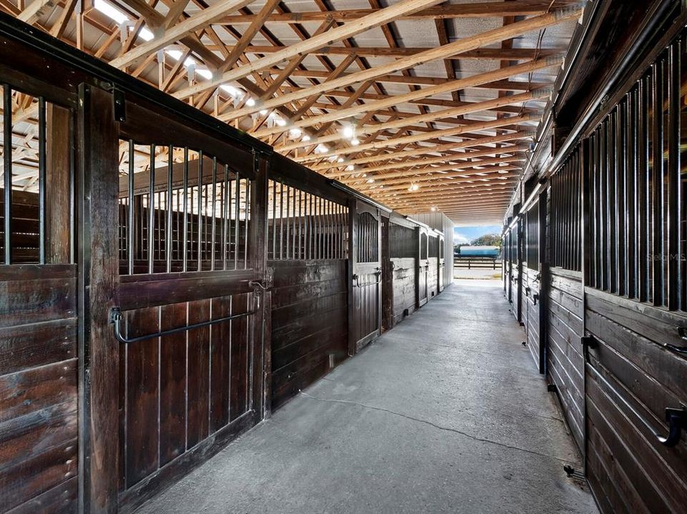 12x12 stalls on the left, while 12x10 stalls on the right also open to paddock areas