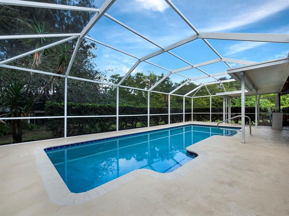 Screened pool area with large patio is a private oasis