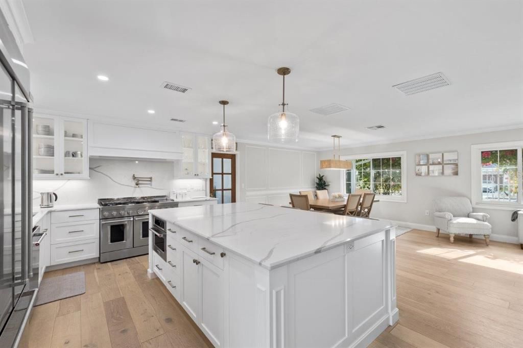 Gourmet Kitchen featuring quartz, custom cabinetry, and commercial grade Kitchen Aid appliances.