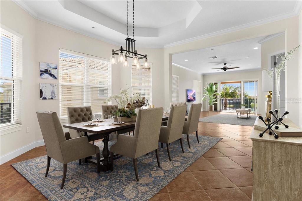 VIRTUALLY STAGED Dining Room, looking into Living room and Lagoon view beyond from amazing covered patio.