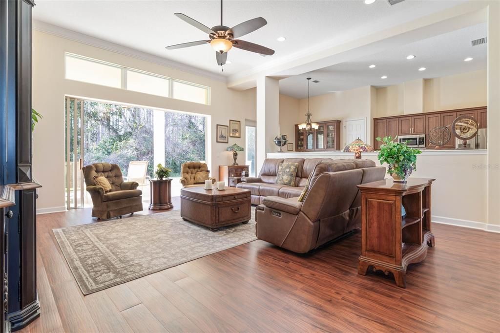 Large living room with vanishing sliding glass doors.