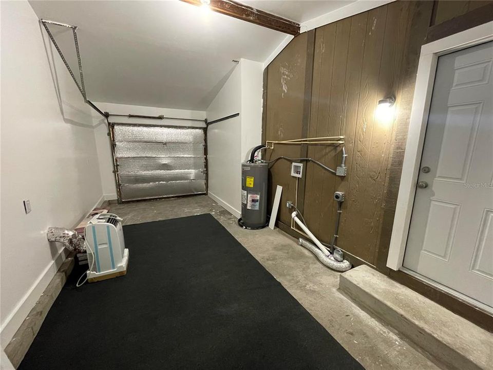 Garage with AC unit and washer and dryer hookups