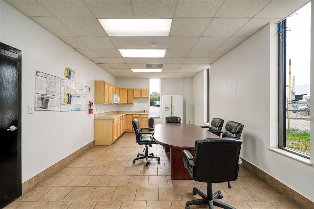 Kitchen furnished with Refrigerator and Built-in Microwave. An additional Breakroom off Warehouse