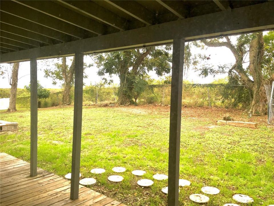 View of backyard from under the covered porch area
