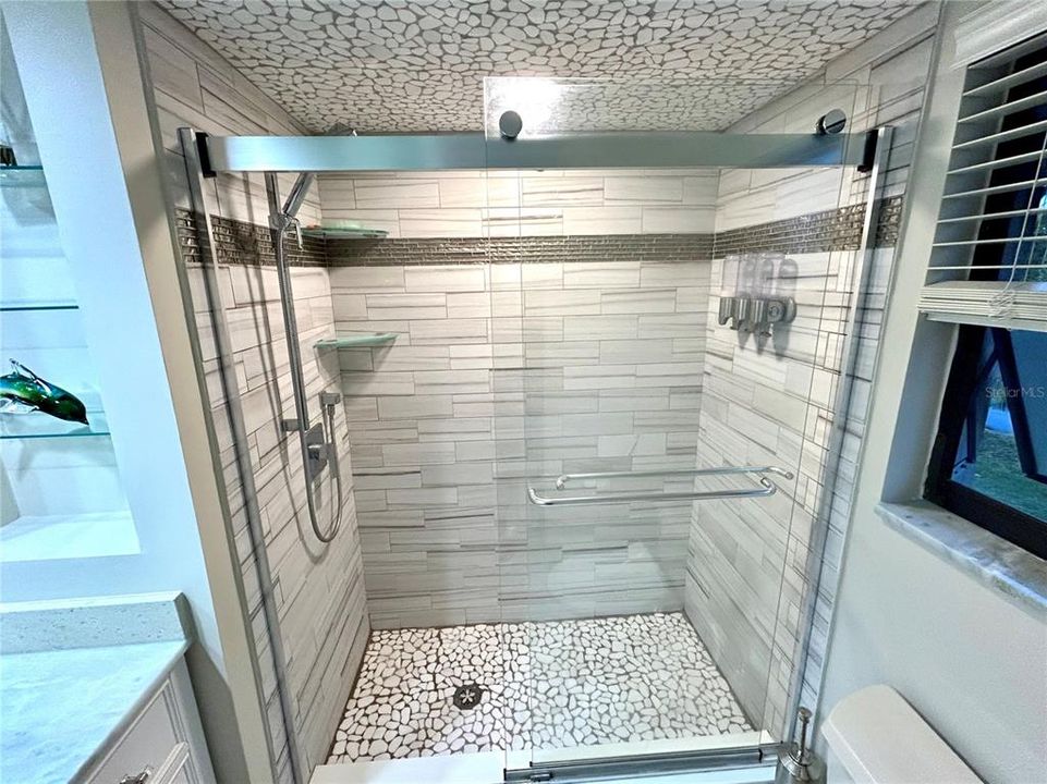 The en-suite has a custom shower.