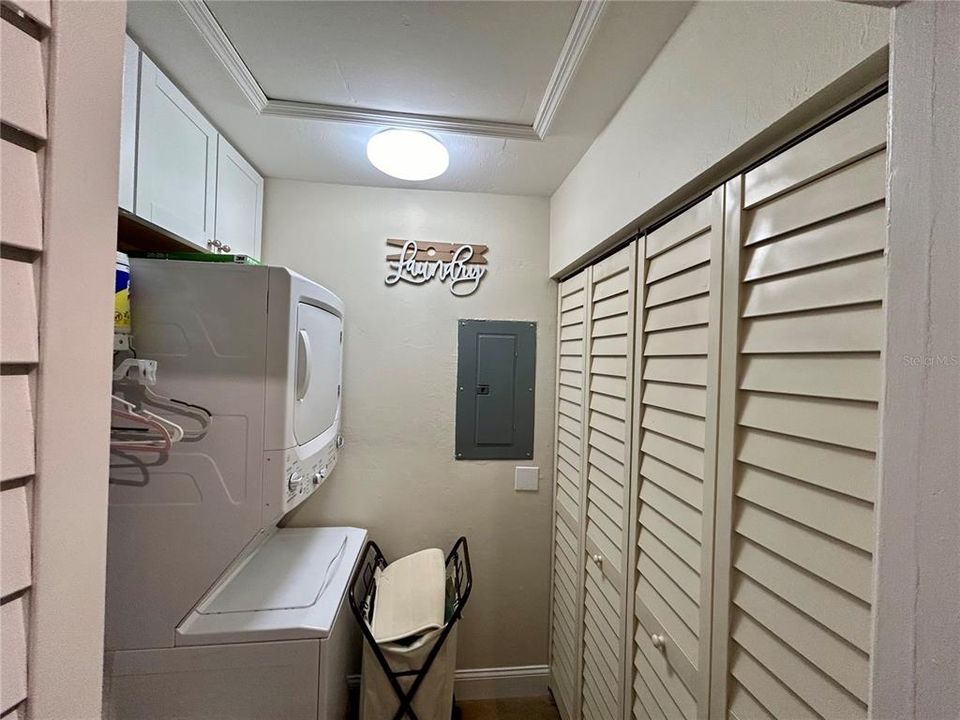 The laundry room with lots of storage -- even a few sets of golf clubs!