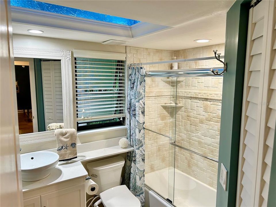 This bathroom has a shower/tub, solid wood cabinets, and lots of upgrades.