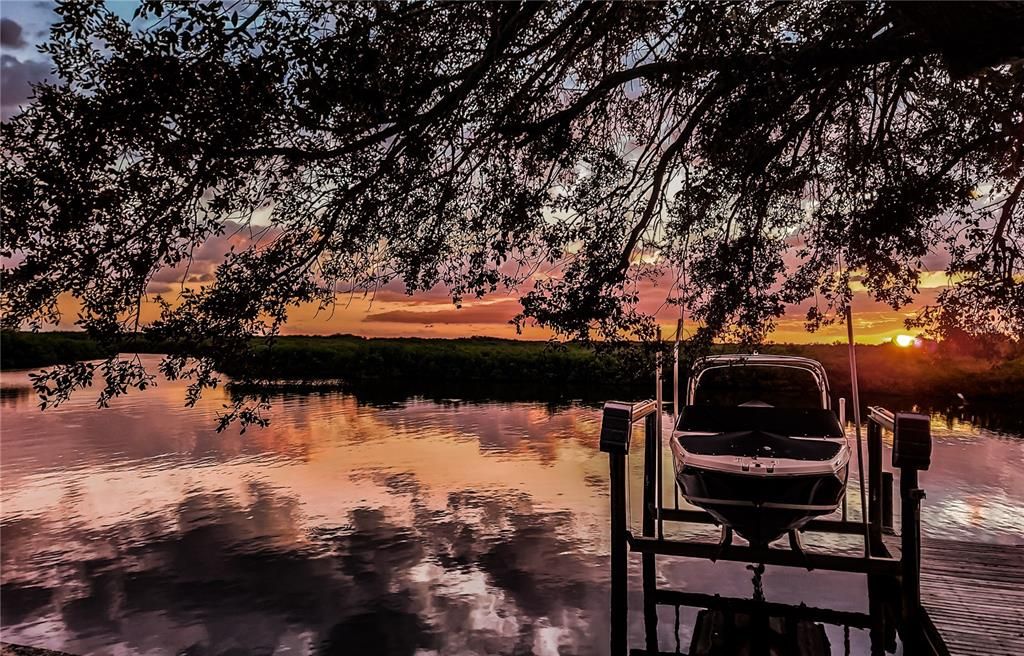 Your picture-perfect sunset view and boat dock.