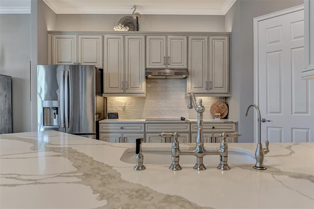 Custom Sink, plumbing, lighting, and tile work really make the kitchen a showcase.