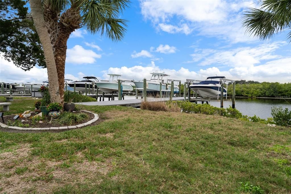 Side yard (maintained by association) with view of dock/boat lift