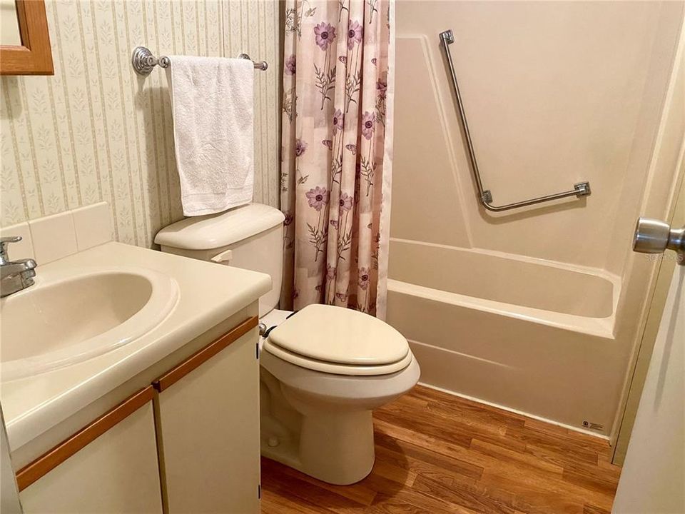 Walk-through bathroom that's accessible via hallway and laundry room.