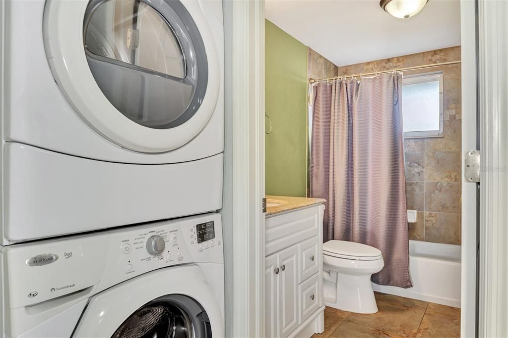 LAUNDRYROOM IN THE SECOND HOME IS LOCATED IN THE HALLWAY NEXT TO THE BATHROOM.