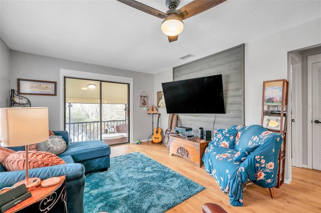Living room leads to balcony that overlooks the community lake