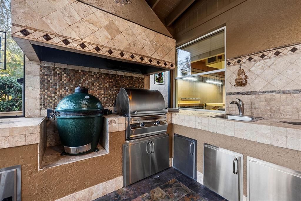 Screened outdoor kitchen with green egg smoker