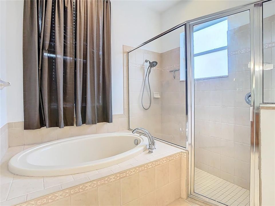 Primary Bathroom with Dual Sinks, Private Water Closet, Garden Tub, and Walk-In Shower