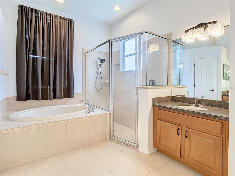Primary Bathroom with Dual Sinks, Private Water Closet, Garden Tub, and Walk-In Shower