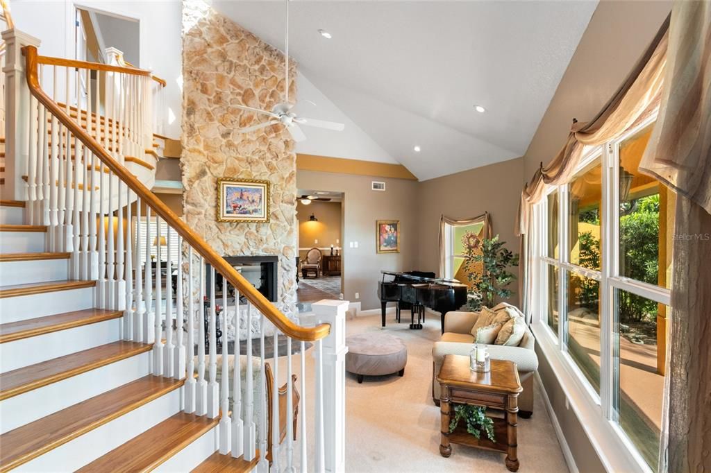 Custom built staircase enhances the luxurious family room