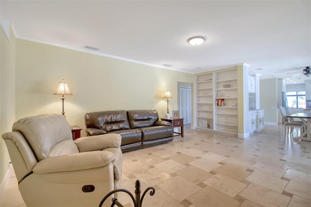 family room looking towards the dining room, kitchen and downstairs hallway where the half bath is located