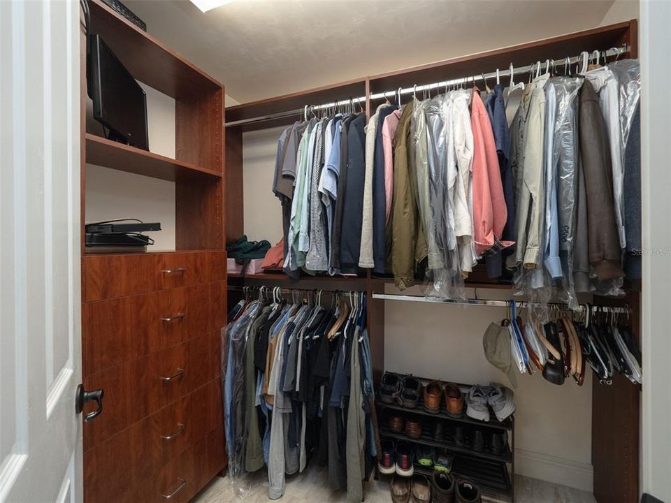 ONE OF TWO WALK IN CUSTOM CLOSETS IN OWNER'S SUITE