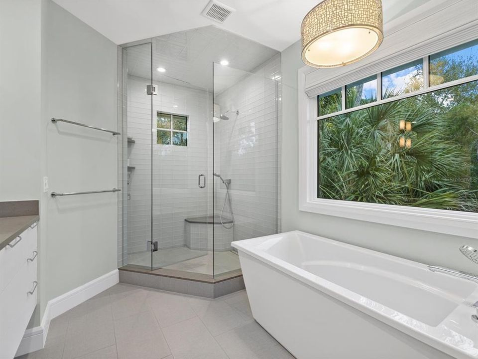Primary bathroom with glass shower & soaking tub