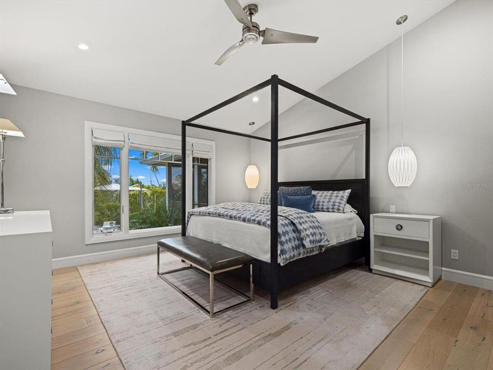 Primary bedroom with a view of the tropical pool